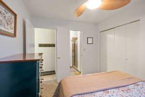 Bedroom with ceiling fan and a closet