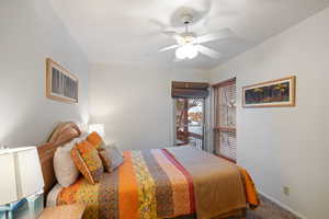 Carpeted bedroom with ceiling fan and baseboards