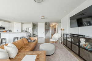 Living room featuring light wood-style flooring and stairs