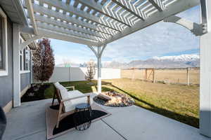 View of patio / terrace featuring a fenced backyard, a mountain view, and a pergola