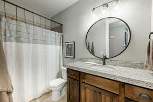 Full bath featuring vanity, toilet, and tile patterned floors