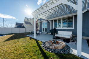 Exterior space with entry steps, an outdoor fire pit, fence, a patio area, and a pergola