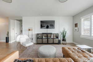 Living area with baseboards and wood finished floors