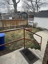 View of yard with fence and a patio