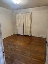 Spare room with dark wood finished floors and baseboards