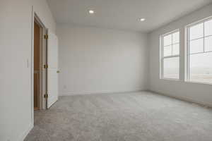 Unfurnished room featuring recessed lighting, visible vents, baseboards, and light colored carpet