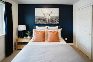 Bedroom featuring baseboards and light colored carpet