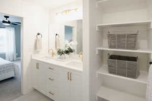 Ensuite bathroom with ceiling fan, a sink, ensuite bath, and double vanity