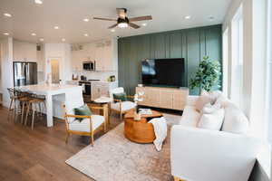 Living area featuring wood finished floors, a ceiling fan, and recessed lighting