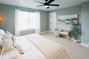 Bedroom featuring light carpet, recessed lighting, a ceiling fan, and baseboards