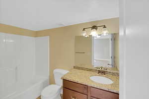 Second Full bath in the basement featuring toilet, shower / bath combination, visible vents, and vanity