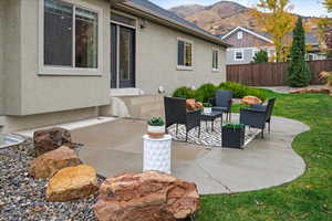 View of patio featuring a mountain view and fence