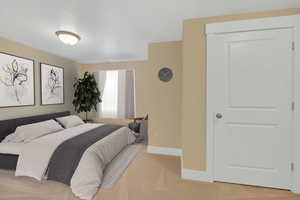 Bedroom with light colored carpet and baseboards