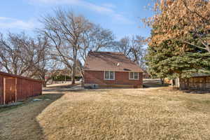 View of side of property with a lawn