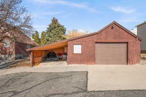 Garage featuring a carport