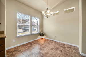 Unfurnished dining area featuring visible vents, stairway, an inviting chandelier, vaulted ceiling, and baseboards