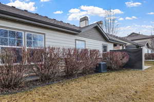 View of property exterior featuring cooling unit and a yard