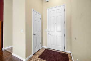 Doorway to outside featuring baseboards