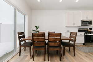 Dining area with hardwood / wood-style floors