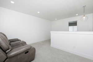 Living area featuring light colored carpet