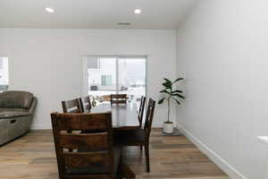 Dining area with hardwood / wood-style floors