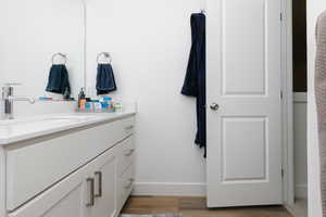 Bathroom with hardwood / wood-style flooring and vanity