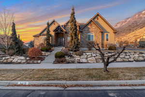 View of front facade with stone siding and stucco siding