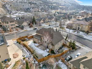 Snowy aerial view featuring a residential view and a mountain view