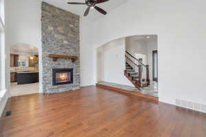 Unfurnished living room with visible vents, wood finished floors, and ornamental molding