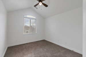 Bedroom with lofted ceiling, baseboards, and a ceiling fan