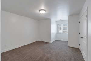 Bedroom 2 featuring baseboards and carpet flooring