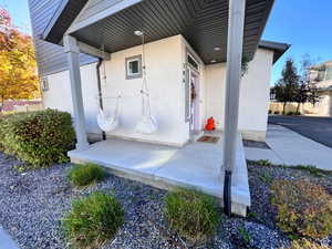 View of exterior entry featuring stucco siding