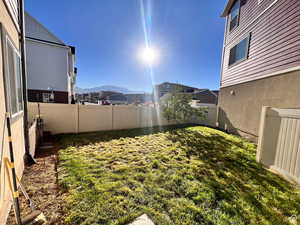 View of yard featuring a fenced backyard and a mountain view