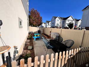 View of patio featuring a fenced backyard, a residential view, and central AC