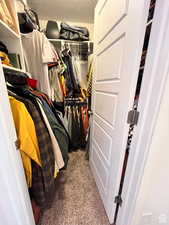 Walk in closet with carpet flooring