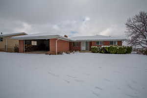 Single story home featuring brick siding