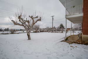 Yard covered in snow with a garage