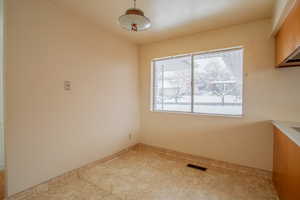 Unfurnished dining area featuring visible vents