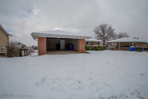 Exterior space with a garage and brick siding