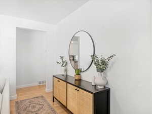 Interior space featuring visible vents, baseboards, and light wood finished floors
