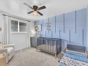 Bedroom featuring baseboards, visible vents, ceiling fan, and light colored carpet