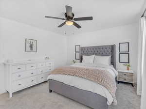 Bedroom featuring a ceiling fan and light colored carpet