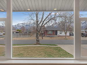 View of yard with a mountain view and fence