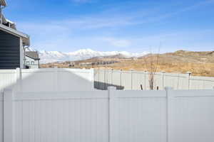 View of yard featuring a fenced backyard and a mountain view