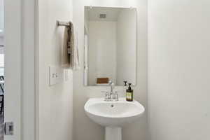 Bathroom featuring visible vents and a sink