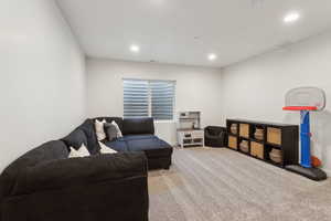 Living room featuring carpet, visible vents, baseboards, and recessed lighting