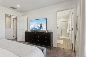 Bedroom featuring recessed lighting, visible vents, and ensuite bathroom