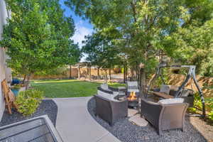 View of patio with an outdoor living space with a fire pit and a fenced backyard