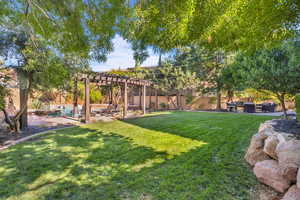 View of yard featuring a patio, a fenced backyard, and a pergola