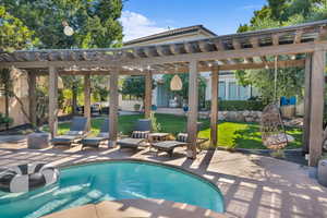 Outdoor pool featuring a patio, fence, and a pergola